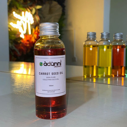 a bottle of Adunni Organics Carrot Seed Oil