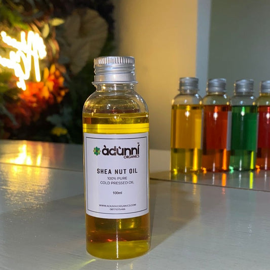 bottle of adunni organics pure shea nut oil on a white shelf